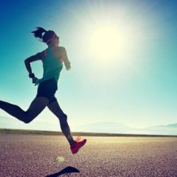 young fitness woman runner running on sunrise seaside trail