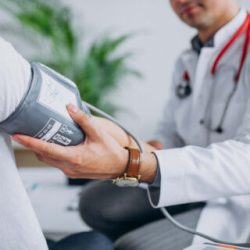 young-male-psysician-with-patient-measuring-blood-pressure-1-320x320